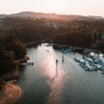 Marina o zachodzie słońca z zacumowanymi łódkami w spokojnej wodzie