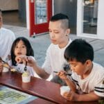 Rodzina jedząca lody na świeżym powietrzu latem